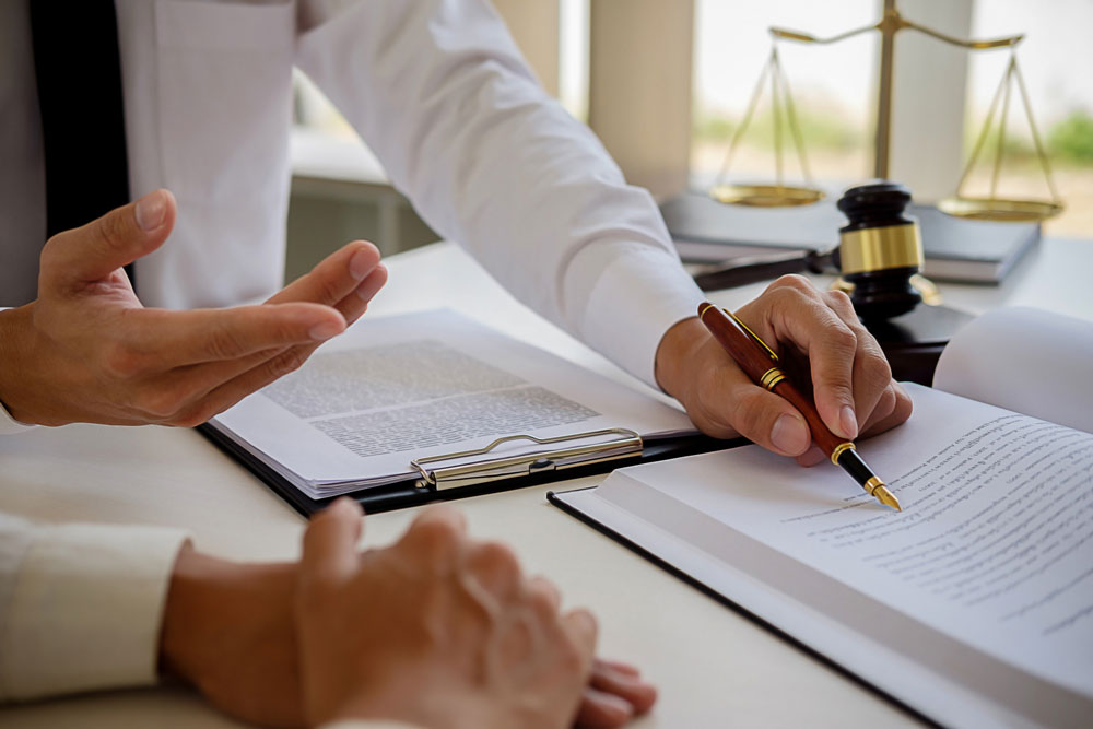 Legal counsel presents to the client a signed contract with gavel and legal law